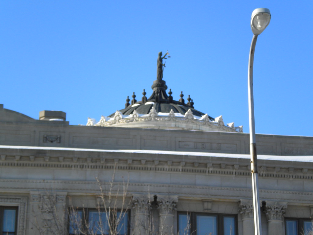 A courthouse building topped with a statue of Lady Justice