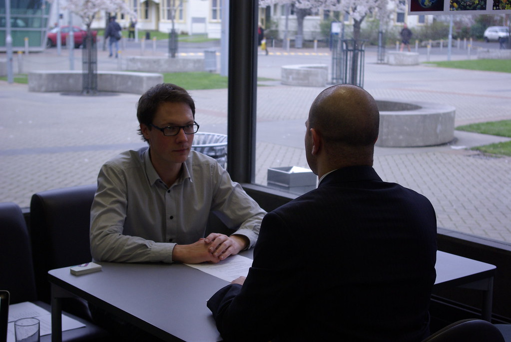 Two men in conversation across a table